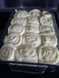 a pan filled with rolls sitting on top of a stove