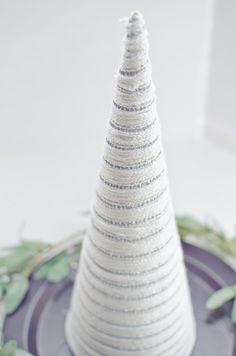 a white christmas tree sitting on top of a plate