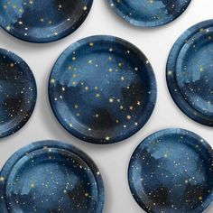 six blue plates with gold stars painted on them