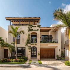 a large house with palm trees in front of it