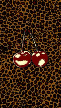 two cherries on a leopard print background