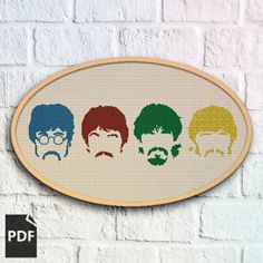 the beatles cross stitch pattern on a white brick wall