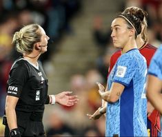 two female soccer players talking to each other