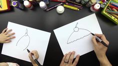 two people drawing on paper with markers and crayons