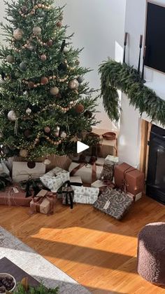 a living room with a christmas tree and presents on the floor in front of it