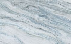 a white marble counter top that looks like it has been painted with blue and grey paint