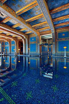 an indoor swimming pool surrounded by blue tiles