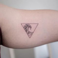 a man's arm with a tattoo on it that has a wave in the triangle