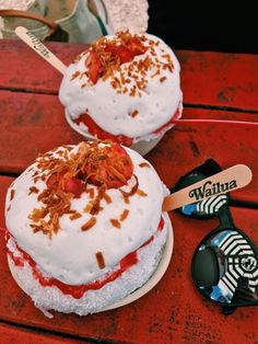 two desserts sitting on top of a red table