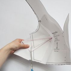 someone is cutting out an origami piece from paper with scissors and threads