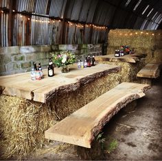 an outdoor event with hay bales and beer bottles on the tables in front of them