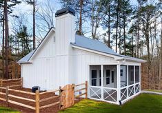 a small white building with a porch and stairs