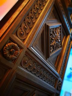 an ornate wooden door with decorative carvings on it