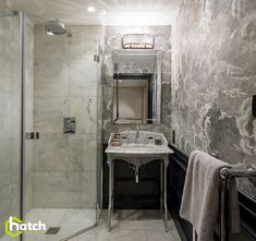 a bathroom with marble walls and flooring