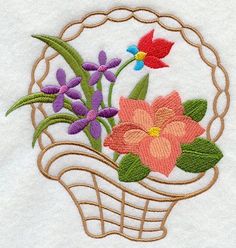 a basket filled with flowers on top of a white towel next to a red flower