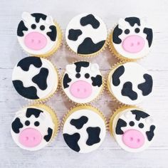 cupcakes decorated with black and white cow's faces on top of each other