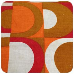 an orange and white fabric with circles on it