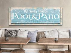 a wooden sign that says the smith family pool and patio sits on a wall in a restaurant