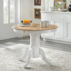 The 3pc Hawthorne Round Dining Set from Buylateral is sure to enhance your dining space with charm. The round modern farmhouse design creates a cozy interactive space for family and guests to gather. With its natural and white two-tone finish, and 40 inch diameter, this table is an ideal fit for smaller spaces. Constructed of environmentally friendly solid rubberwood, the table features a turned footed pedestal base for added interest. The matching two-tone spindle back Windsor dining chairs fea Oak Table Makeover, White Washed Bedroom Furniture, Painting Dining Table, Kitchen Round Table, Silver Buffet, Sage Green Furniture, Dining Table Blue, Breakfast Tables, Kitchen Nooks