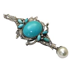 This is part of Chairish’s Fine Jewelry assortment.  METAL: palladium WEIGHT: 9 grams STONES: Turquoise, 10.02 cts.; Diamonds, .94 ct. CONDITION: Excellent  Persian Turquoise Palladium Pendant South Sea Pearl. This gorgeous Persian turquoise pendant is set in palladium (cousin to platinum but lighter in weight). The center turquoise has a color grade of light greenish blue with an estimated carat weight of 9.08 carats (18.62 x 15.35 x 5.76). There are six marquise cut turquoise of the same color Exquisite Turquoise Jewelry For Formal Occasions, Elegant Silver Turquoise Necklace, Elegant Turquoise Cabochon Necklace, Elegant Turquoise Cabochon Pendant Necklace, Luxury Turquoise Cabochon Necklace, Elegant Blue Turquoise Necklace With Cabochon, Elegant Blue Cabochon Turquoise Necklace, Elegant Blue Turquoise Cabochon Necklace, Persian Turquoise