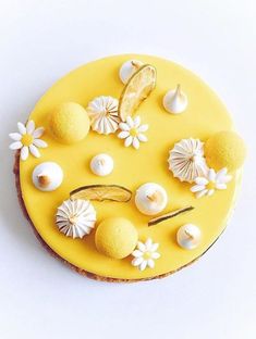 there is a yellow cake decorated with shells and flowers on the top, as well as a banana