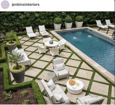 an outdoor patio with chairs and tables next to a swimming pool in the middle of it