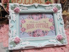 there is a blue frame with pink roses on it that says welcome to my rose cottage