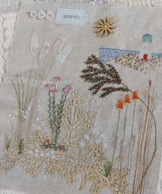 a close up of a piece of cloth with flowers and plants on it's side