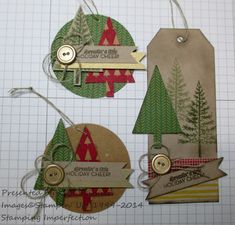 three tags that have been made to look like christmas trees