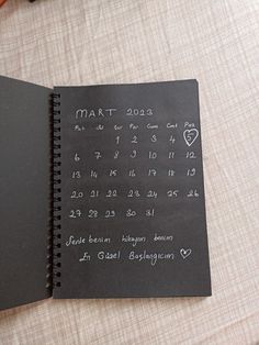 a black notebook with writing on it