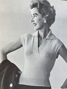 an old black and white photo of a woman wearing a sweater