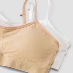 Designed with her comfort in mind, this Girls' Solid 2 Pack Seamless Bra from art class is just right for a first-time wearer. The set features white and beige bras for versatile use. The seamless bra with lightly lined cups promises a streamlined silhouette. The adjustable straps can also be styled in a crossback manner for a more customized fit. This pack from art class is perfect to start her day off comfortably. Welcome to Art Class, where style is what you make it. White Seamless Casual Bra, White Micro-elastic Seamless Bra, White Cotton Sports Bra With Built-in Bra, Everyday Seamless White Bra, Everyday White Seamless Bra, Bra Art, White And Beige, Seamless Bra, Art Class