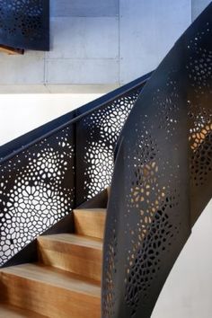 an artistic stair railing with laser cut designs