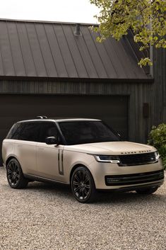 a range rover parked in front of a garage