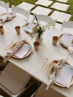 the table is set with place settings and napkins for guests to enjoy their meal