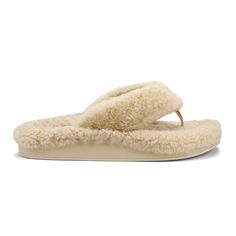 a women's slipper with sheep fur on the bottom and an open toe