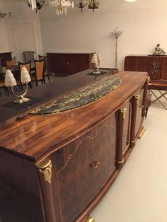 a large wooden cabinet sitting in the middle of a room filled with tables and chairs