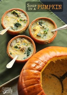 three pumpkin bowls filled with soup on top of a table