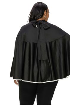 Introducing the perfect accessory to elevate any outfit - our fashionable layering cape! Made with a soft and cozy fabric, this cape features a relaxed fit and draped design that effortlessly complements any body type. Rear ribbon closure Contrast binding 95% Polyester 5% Spandex Machine wash cold, tumble dry low Made in USA Cozy Fabric, Designer Drapes, Poncho Cape, Body Types, Neck Tie, Binding, Cape, Layering, Ribbon