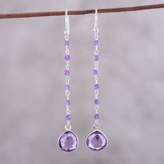 Glistening amethyst gems fall from the ears, punctuated by glistening teardrops at the bottom of these Indian dangle earrings. Neetu Barathi designs the earrings, crafting them with hooks and links of sterling silver.