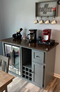 a kitchen with a counter, coffee maker and other items on the wall above it