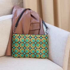 Meet your new go-to bag for all things retro and funky! Our bold orange and brown geometric crossbody bag screams 70s mod fashion. With its flower power print, it's the perfect accessory to add a splash of mid century modern style to any outfit. Say goodbye to boring bags and hello to playful fashion statements! Crafted from premium faux leather with sleek dark gray hardware, this crossbody bag ensures your essentials stay secure and organized with its zip-top closure and multiple interior pockets. Easily switch between day-to-night looks using the removable wrist and shoulder straps for versatile styling.• Outer fabric: faux leather • Lining: 100% polyester• 11″ × 8″ × 1.5″ (27.9 cm × 20.3 cm × 3.8 cm)• Dark gray hardware• Zip-top closure• Inside zip and slip pockets• Adjustable, removabl Playful Fashion, 70s Mod, Fashion Statements, Mod Fashion, Retro 70s, Mid Century Modern Style, Orange Brown, Modern Fashion, Zip Top