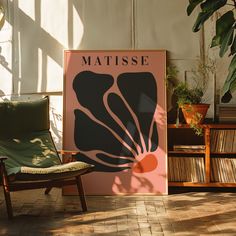 a chair sitting in front of a poster on the wall next to a potted plant