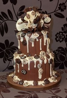 a three tiered cake with chocolate and white icing