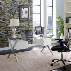 an office with a desk, chair and bookshelf in front of a stone wall