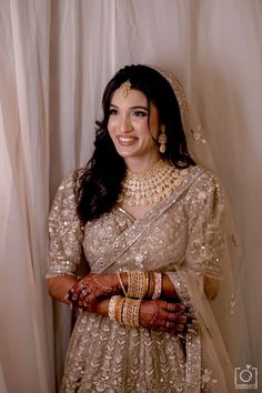 a woman in a bridal outfit posing for the camera