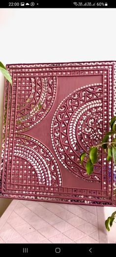 a pink tray sitting on top of a table next to a potted plant