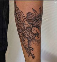 an eagle tattoo on the leg of a man