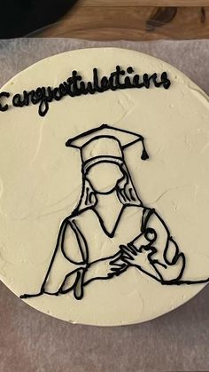 a cake decorated with the words congratulations and a drawing of a woman in a graduation cap