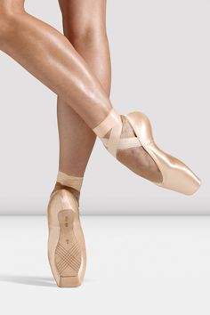 a woman's feet in ballet shoes with her leg wrapped around the ankles and one foot up